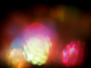 Colorful light leaks on black background for design and special effects. Retro film look. Abstract colorful light beams.