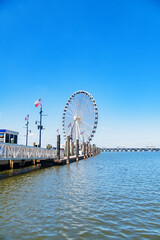 Ferris wheel at Washington DC’s National Harbor offering breathtaking views of the marina, pier,...
