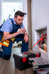 Handyman inspecting heating system in a household repair project during daylight hours