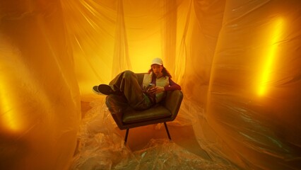 A Contemporary Portrait Set in a Dreamy Yellow Environment Featuring a Cozy Armchair