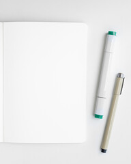 Blank plain white notebook page with a pen