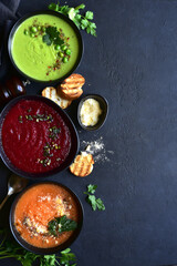 Delicious vegetable soups : carrot, green pea and beetroot. Top view with copy space.
