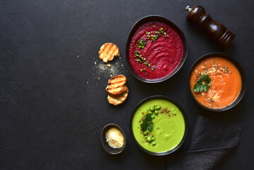 Delicious vegetable soups : carrot, green pea and beetroot. Top view with copy space.