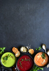 Delicious vegetable soups : carrot, green pea and beetroot. Top view with copy space.