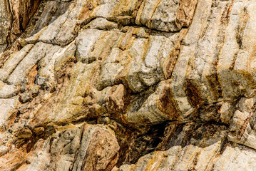 Natural stone texture with cracks, vegetation and dirt, texture background