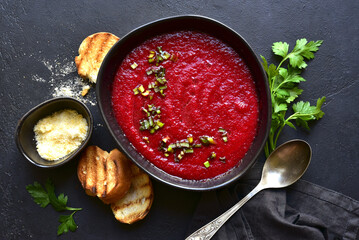 Beetroot soup with parmesan and croutons. Top vie with copy space.