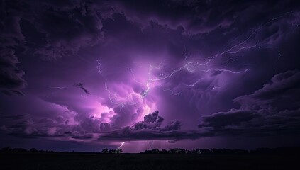 A dramatic nightscape showcasing a powerful lightning strike illuminating a dark, purple-hued thunderstorm above a flat, silhouetted landscape
