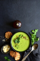 Green pea soup with parmesan and croutons . Top vie with copy space.