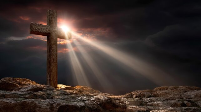 Wooden cross stands on rocky ground with dramatic light rays breaking through dark, cloudy skies, symbolizing spiritual hope and devotion.