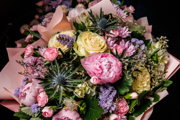 Elegant bouquet of fresh flowers with pink peonies, yellow roses, chrysanthemums and seasonal greenery, perfect decoration for wedding, celebration or romantic gift
