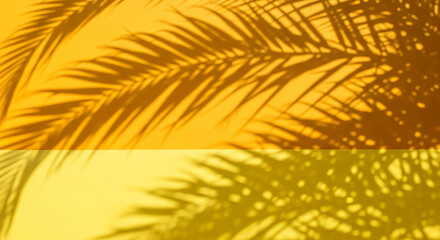Obraz premium Abstract image of palm leaf shadows on yellow background, creating a warm and sunny aesthetic, perfect for summer or tropical themes. Free space for text or logo