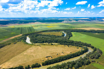 Fototapeta premium The river flows along the fields.