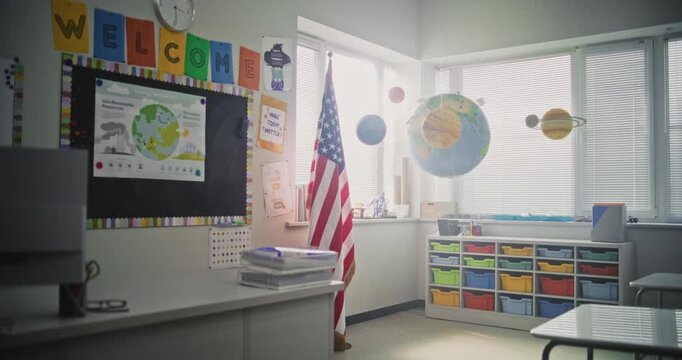 American Elementary School: Interior of Empty Classroom with Desks for Students, Chalkboard, Solar System Models and Colorful Posters. Educational and Inspiring Learning Environment for Children.