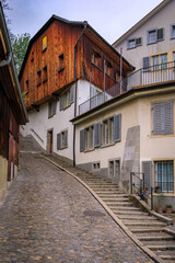 Steep cobblestone street with historic buildings in Zurich Old Town or Altstadt