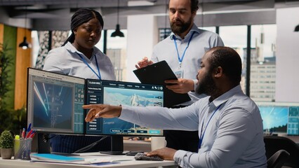 Team of engineers in office doing green energy production technology testing. Teamworking colleagues research cutting edge solutions for biodiversity conservation in renewable energy sector, camera B