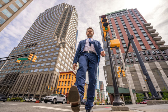 Business man in Manhattan. Business success in big city. Businessman go to success. Successful deal. Low angle. Business success. Busy city street. Successful businessman in New York city street