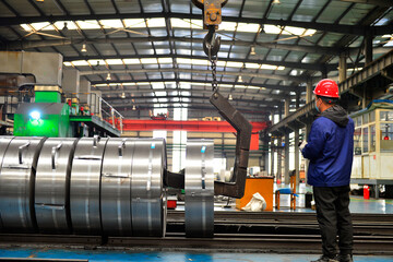 Workers on the production line of the strip steel coil factory are working