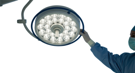 Surgeon's gloved hand adjusts a bright surgical examination light with multiple LEDs in an operating room transparent background