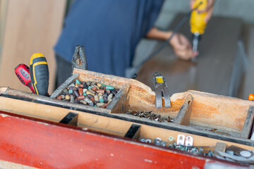 Workshop scene showing organized toolbox and blurred worker using drill