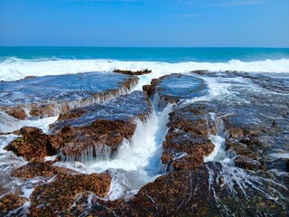 Dramatic Seascape with Coral Reef and Ocean Waves Crashing on Rocky Coastline, Natural Waterfalls, Blue Sky Horizon, Exotic Tropical Travel Nature Photography