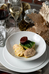 Elegant Escudella Soup on Silver Platter with Red Wine and Champagne – Refined Christmas Dining Scene