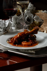 Braised Chicken with Prunes, Dried Peach and Pine Nuts on Silver Platter – Elegant Christmas Dining Scene with Champagne and Wine