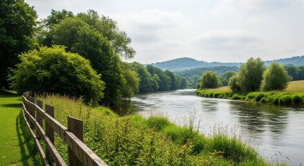 Picturesque riverside vista with lush greenery and rolling hills, inviting serenity and outdoor escape, perfect for nature enthusiasts.