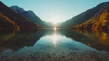 Serene Mountain Lake Sunrise: Golden Reflections and Crystal Clear Waters.