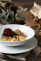 Elegant Escudella Soup on Silver Platter with Red Wine and Champagne – Refined Christmas Dining Scene