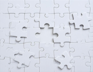 Missing Puzzle Pieces: A close-up of a partially completed jigsaw puzzle, highlighting a few missing pieces, symbolizing the challenge of a complex task.