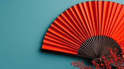 Elegant Red Fan and Berries on Teal Background, Artistic Composition