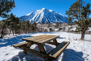 Winter Picnic Spot: Snow-Covered Table with Majestic Mountain Backdrop