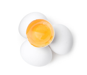 Whole and broken chicken eggs isolated on white, top view