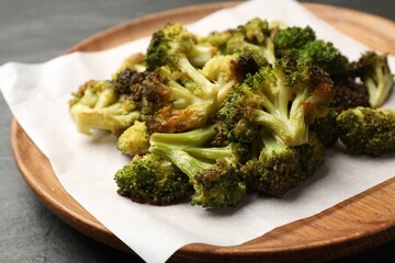 Tasty fried broccoli on black table, closeup