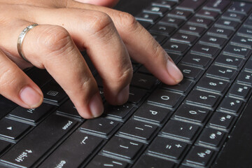 Fingers typing on the keyboard