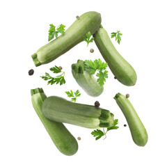 Fresh zucchinis, parsley and peppercorns falling on white background