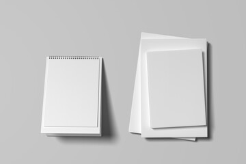 Blank softcover book mockup and blank desktop calendar isolated on white background.