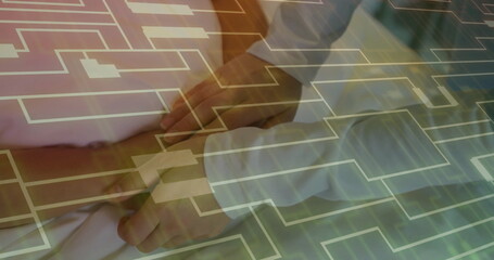 Palpating doctor's hands pressing patient's abdomen in examination room, with digital grid overlay