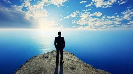 Businessman standing on a cliff overlooking the ocean, facing the horizon.