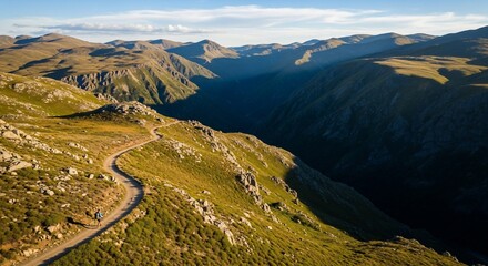 Aerial View of Winding Road Through Mountainous Valley Landscape.