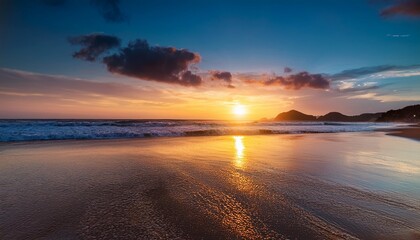 Obraz premium beach at sunset with its captivating beauty reveals blend of warm hues in evening sky shimmering reflection on water and tranquil ambiance of twilight evoking a sense of awe and wonder