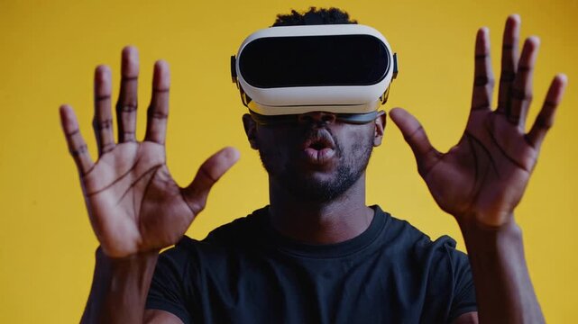 Man of African Descent Utilizing Virtual Reality Headset Against Yellow Colored Backdrop