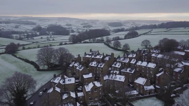 aerial drone shot capturing the village of Haworth and the surrounding Yorkshire scenery during winter day with hazy conditions