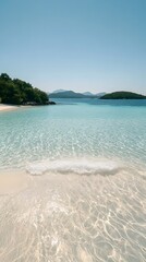 Serene Beach Shore with Crystal Clear Water and Distant Mountains