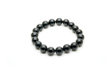 Black jadeite jade bracelet isolated on white background. Natural black color Burmese (Myanmar) jade type A, rosary