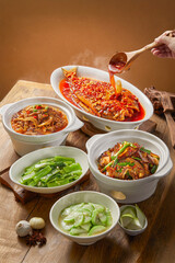 Home cooked Chinese meals in an ordinary Chinese family, with a variety of meat and vegetable dishes placed on the table