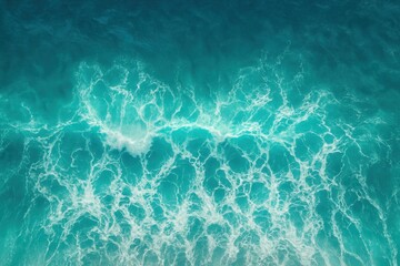 Aerial view of crystal blue ocean waves creating natural patterns and textures from above