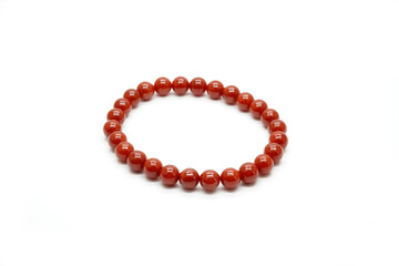 Red jadeite jade bracelet isolated on white background. Natural red color Burmese (Myanmar) jade type A, rosary