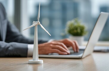 A scene of a wind turbine model with a laptop in an office, used for promoting new energy companies and the concept of commercial sustainable development.