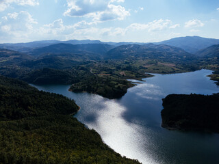 Naklejka premium Aerial view of Rovni Lake reservoir and surrounding hilly landscape in Serbia. g.